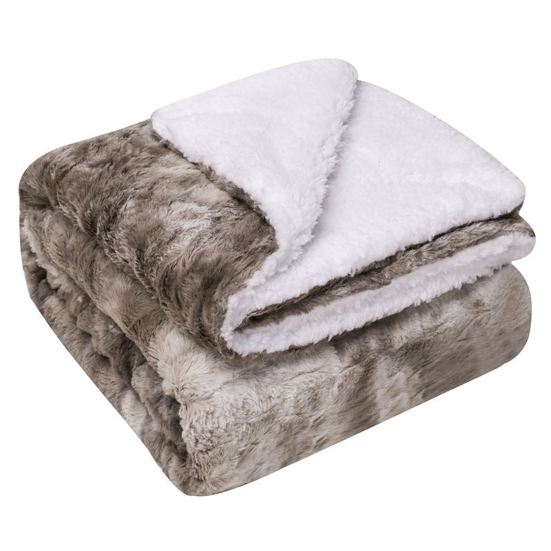 Thick sherpa blanket folded on a sofa
