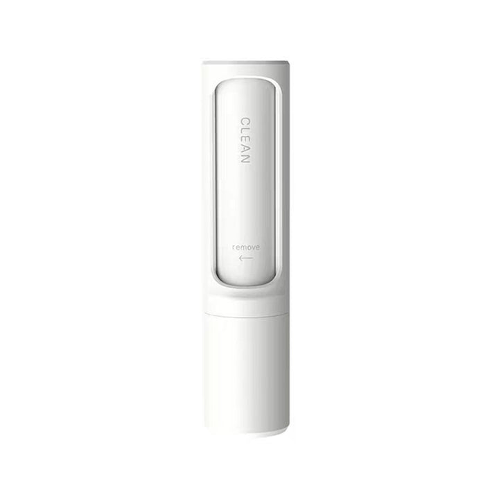 Pet hair remover brush on grey sofa