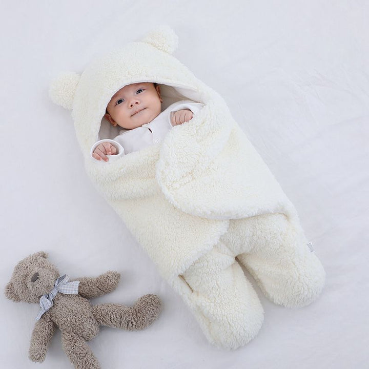 Baby in plush bear-ear hooded wrap