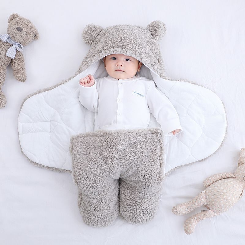 Baby in plush bear-ear hooded wrap