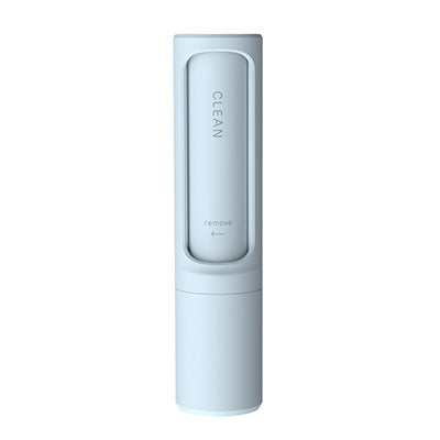 Pet hair remover brush on grey sofa