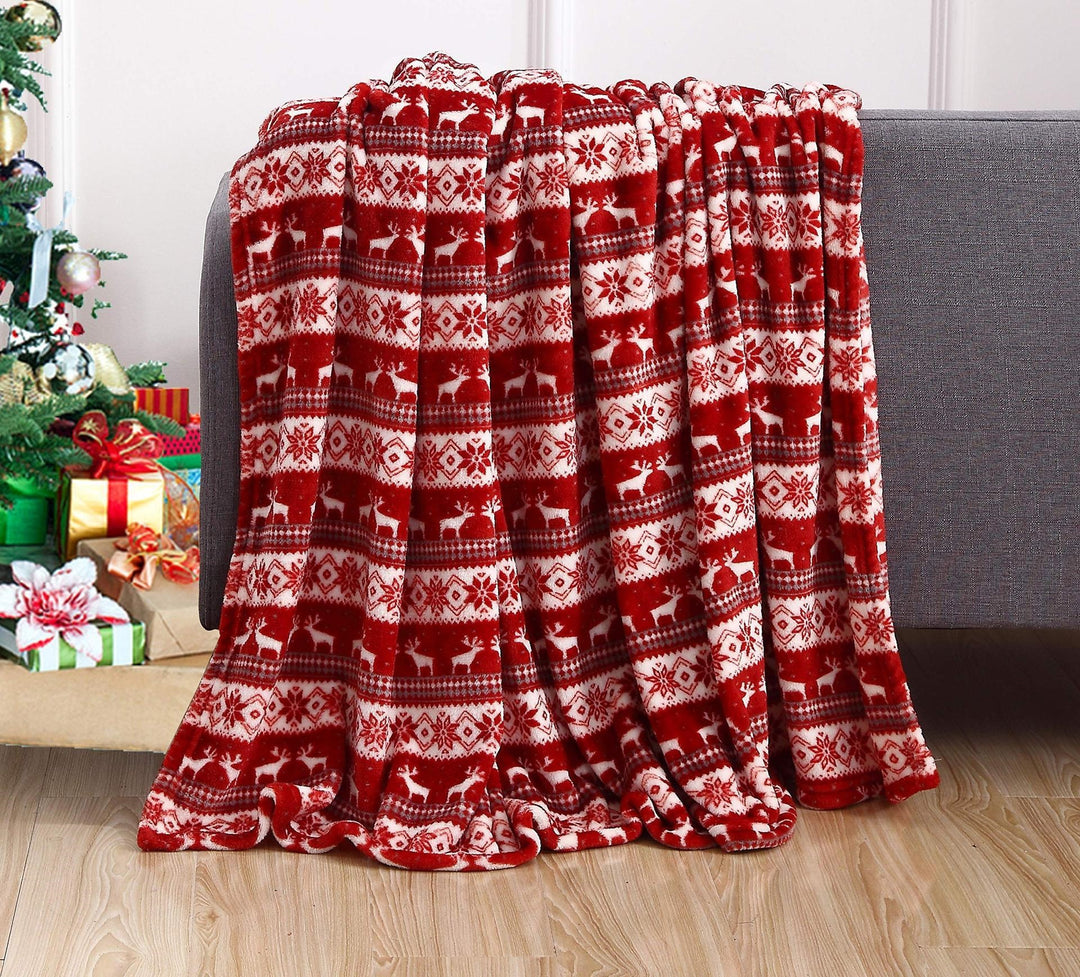 Christmas fleece throw blanket on a sofa