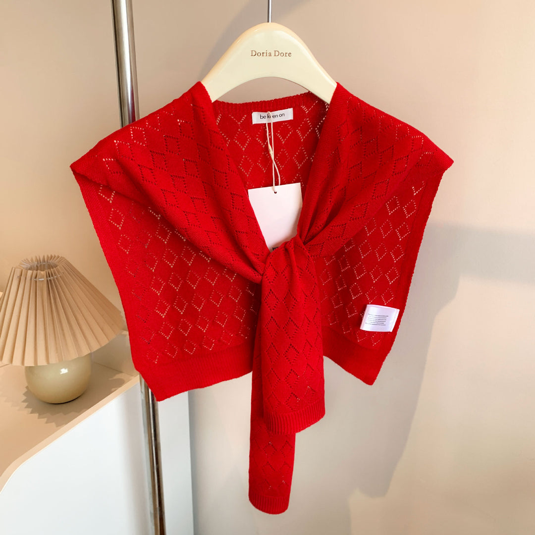 Woman wearing knitted tie front shoulder wrap