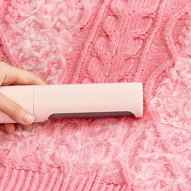 Pet hair remover brush on grey sofa