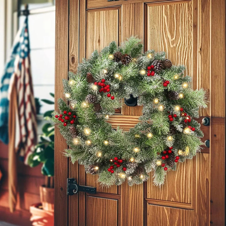 Lit wreath with pine cones and red berries
