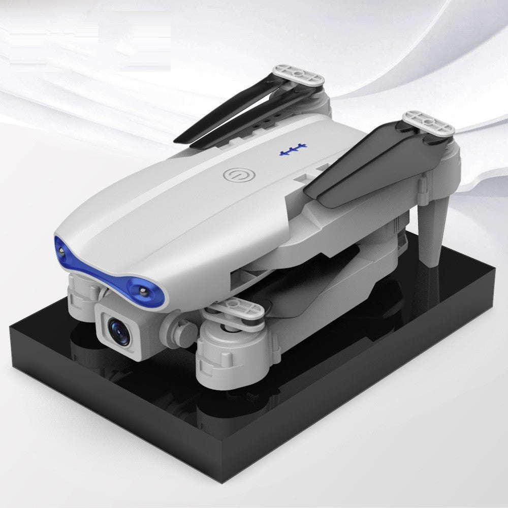 Black foldable drone flying outdoors