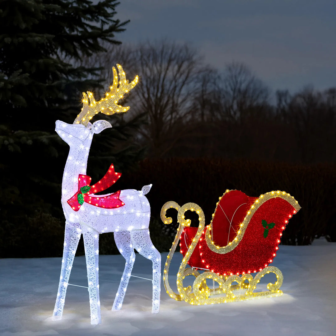 Lit reindeer and sleigh on front lawn