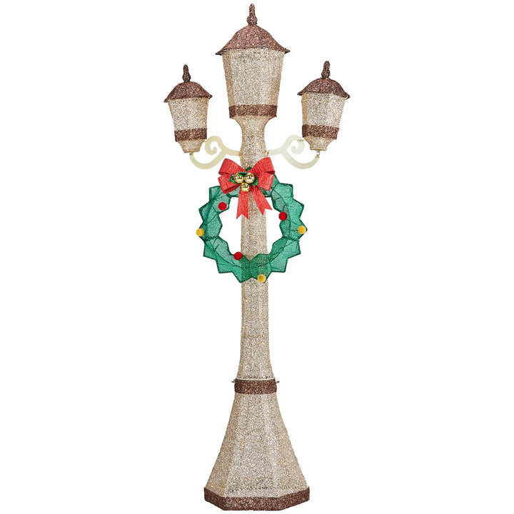 Gold lit Christmas lamp post with wreath