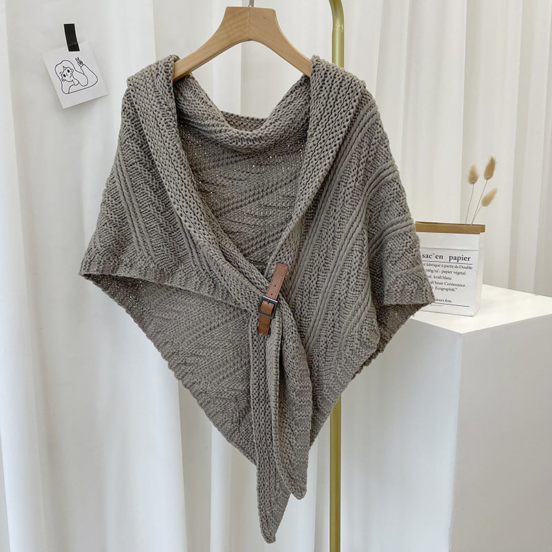 Woman in chunky knit triangle scarf with buckle
