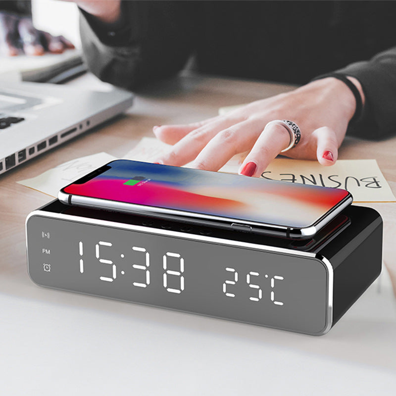 Mirror LED alarm clock charging a phone