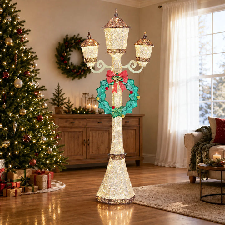 Gold lit Christmas lamp post with wreath