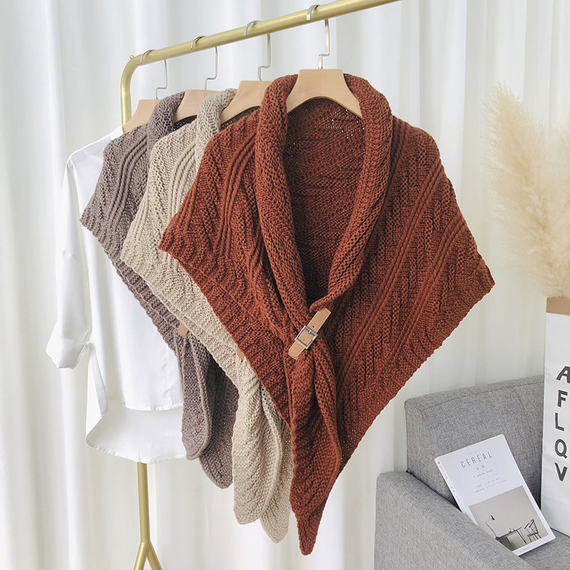 Woman in chunky knit triangle scarf with buckle