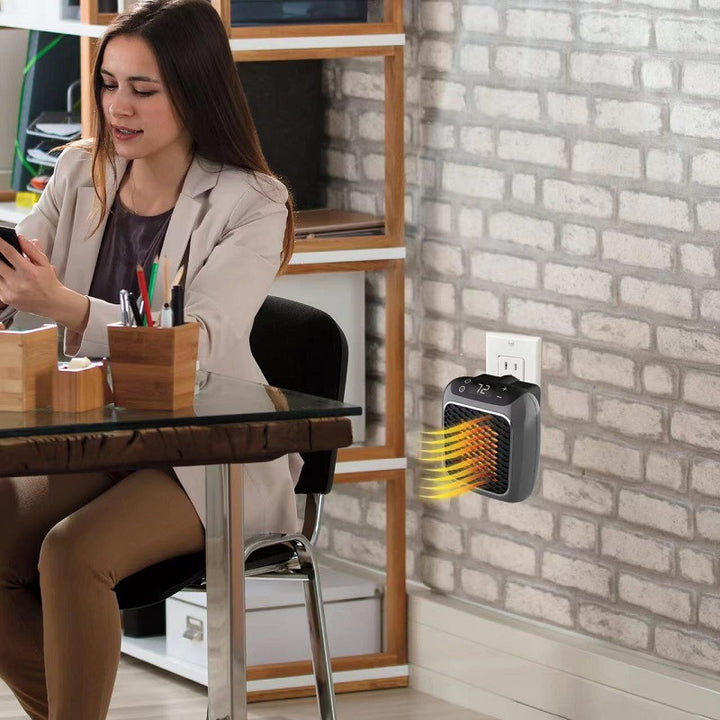 compact grey plug-in heater in a wall socket