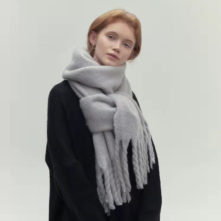 Woman wearing long ivory scarf with tassels