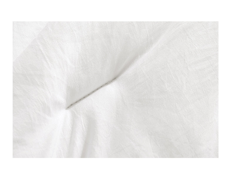 White box-stitched duvet on bed
