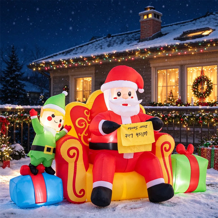 Inflatable Santa on sofa with elf