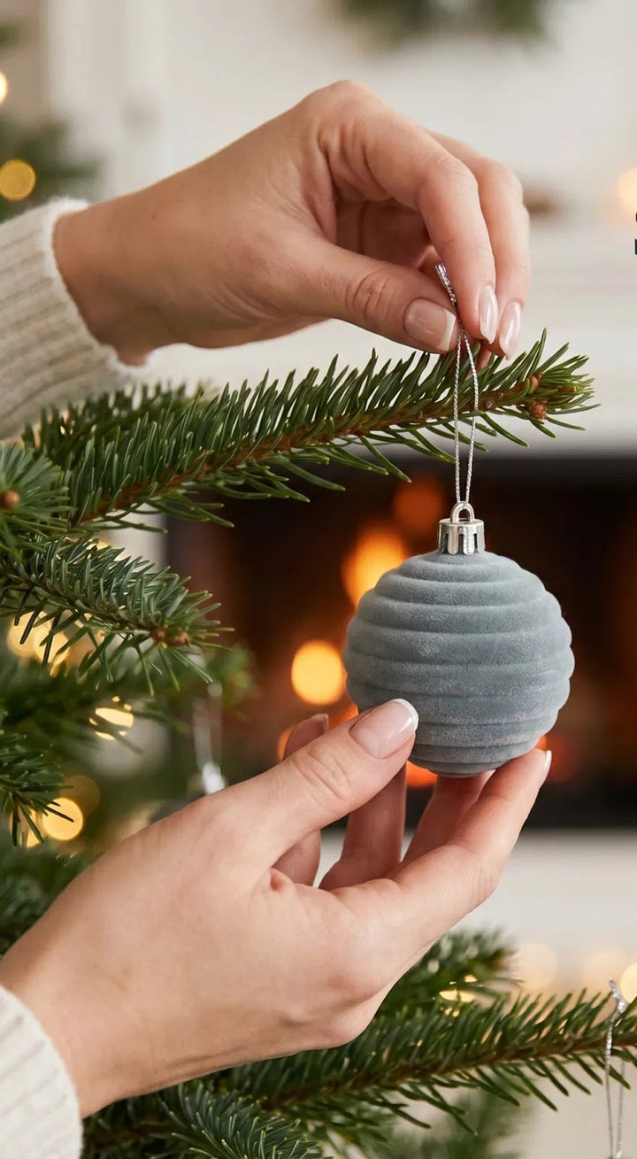Twelve grey velvet Christmas baubles with patterns
