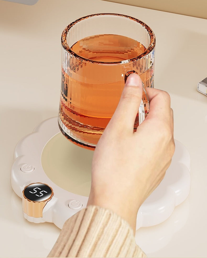 Flower-shaped mug warmer with cup of coffee