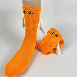 Two socks with magnetic hands holding each other