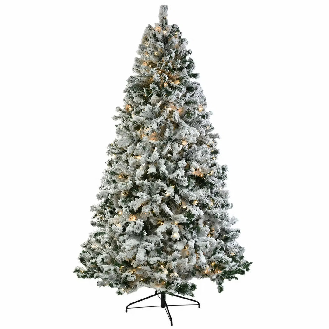 Snow-flocked pre-lit tree glowing white