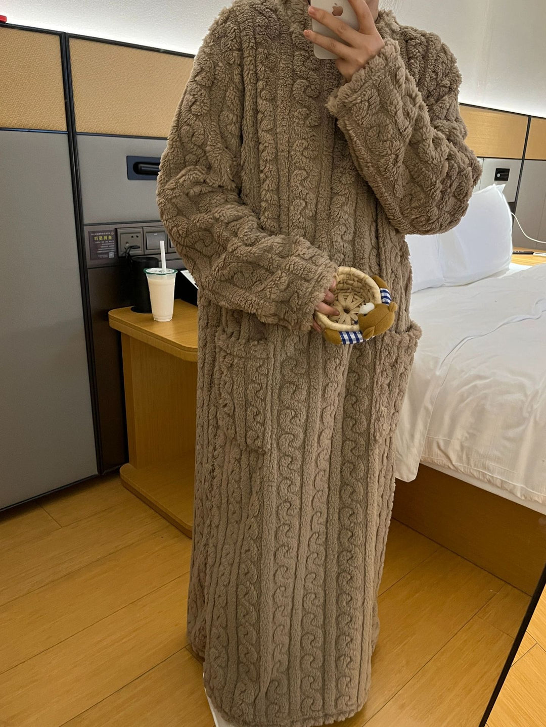 Woman in long pink coral fleece nightgown