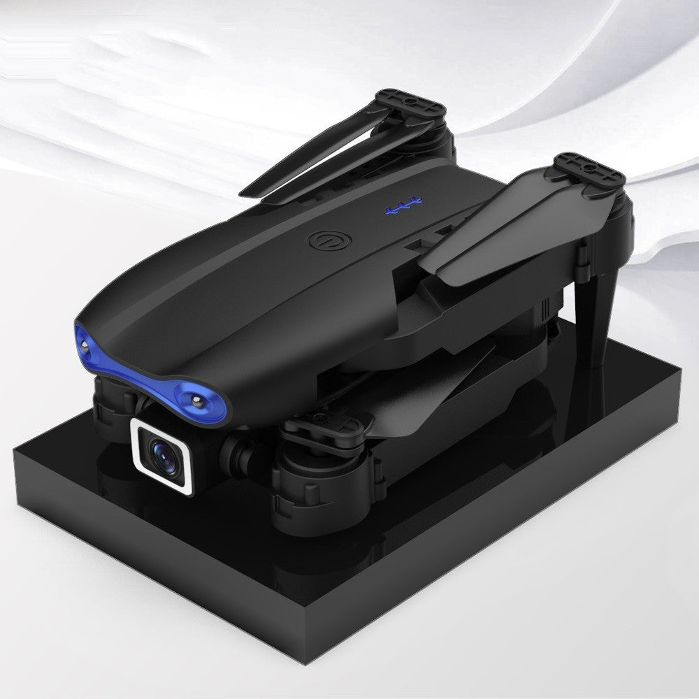 Black foldable drone flying outdoors