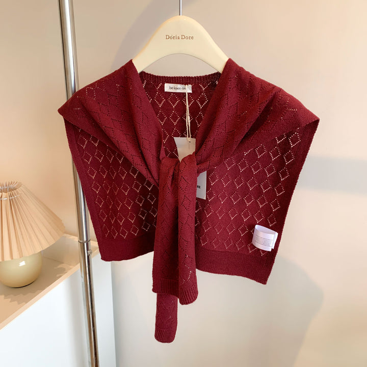 Woman wearing knitted tie front shoulder wrap