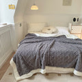 Cream cable knit blanket with sherpa border