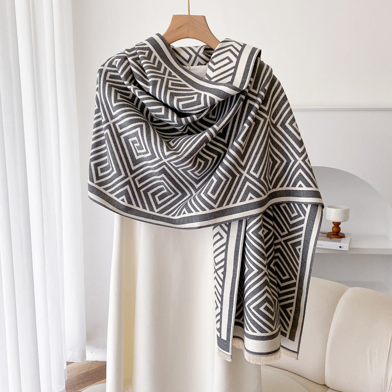 Woman wearing grey fringed shawl cape