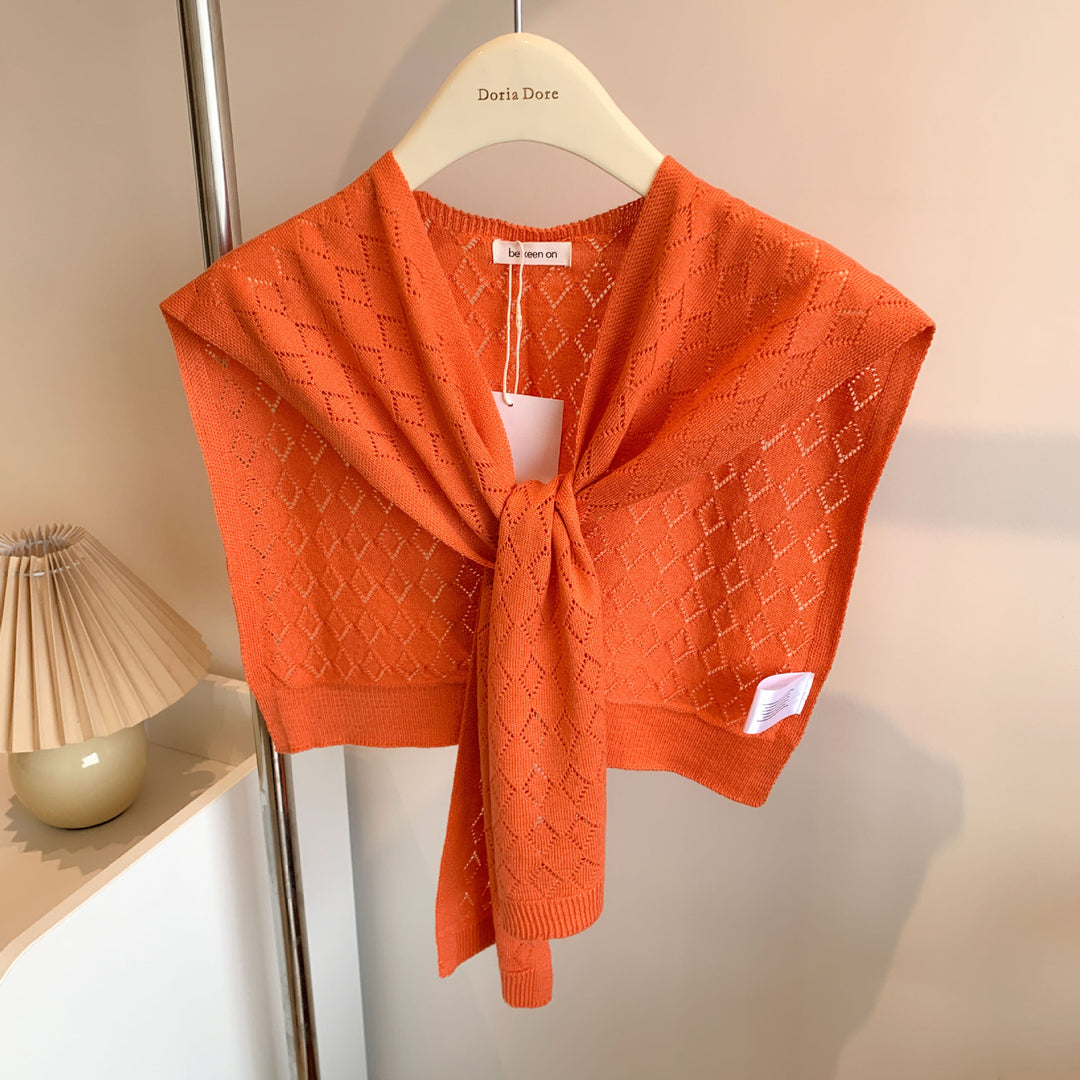 Woman wearing knitted tie front shoulder wrap