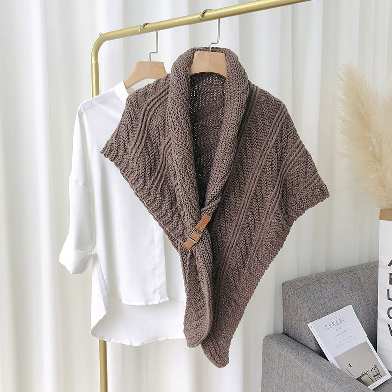 Woman in chunky knit triangle scarf with buckle