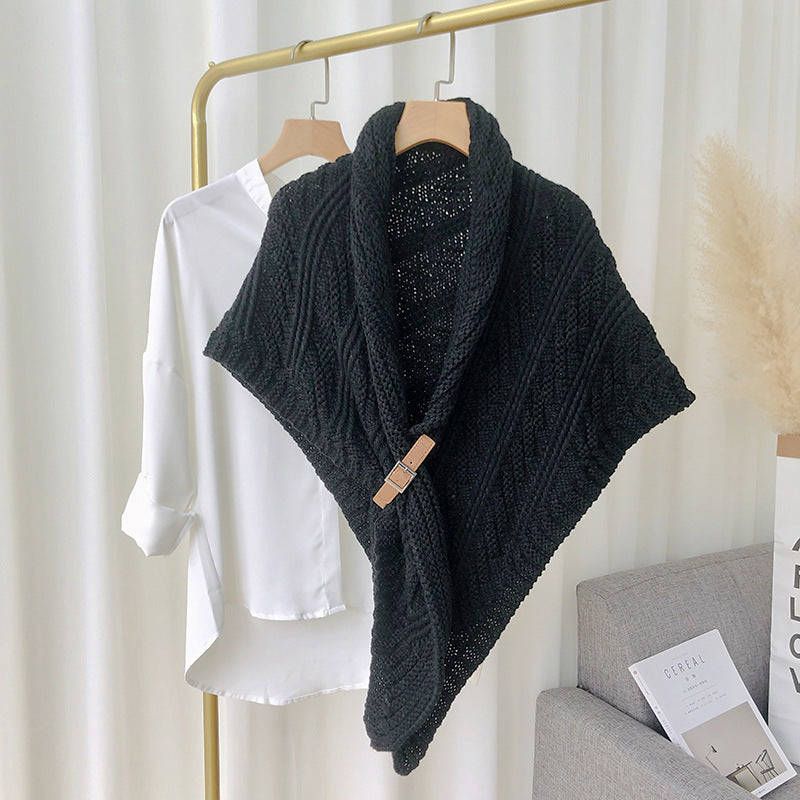 Woman in chunky knit triangle scarf with buckle