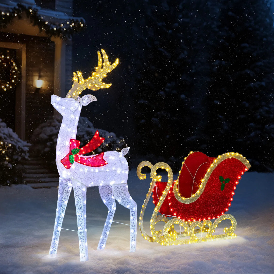 Lit reindeer and sleigh on front lawn