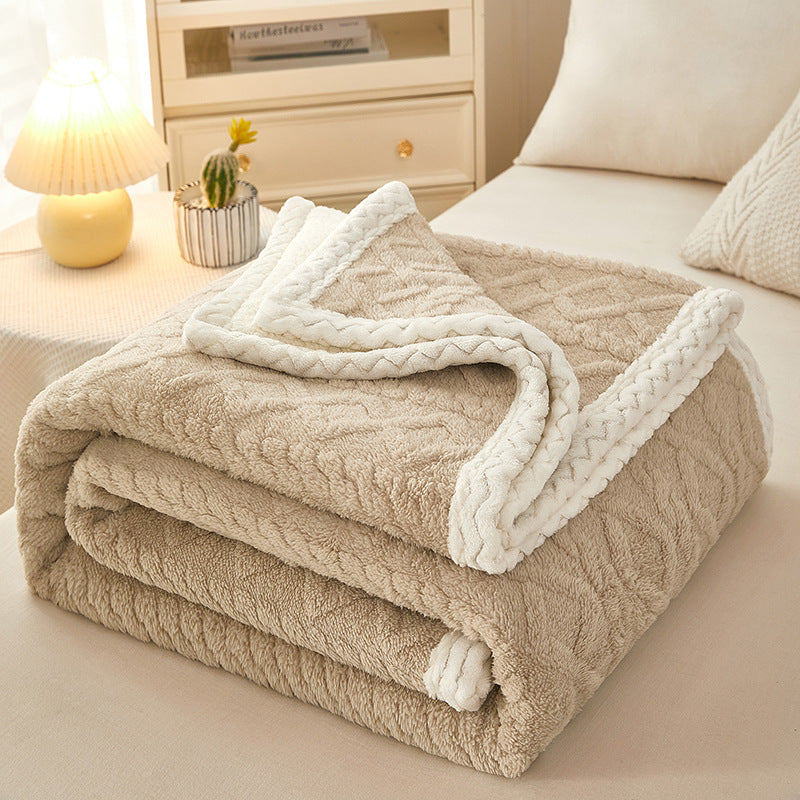 Thick sherpa fleece blanket folded on bed