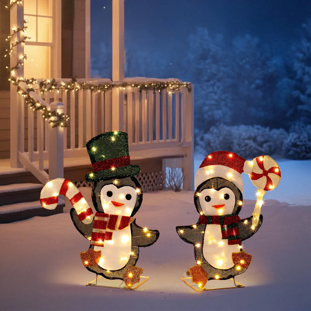 Two light-up Christmas penguins with candy canes
