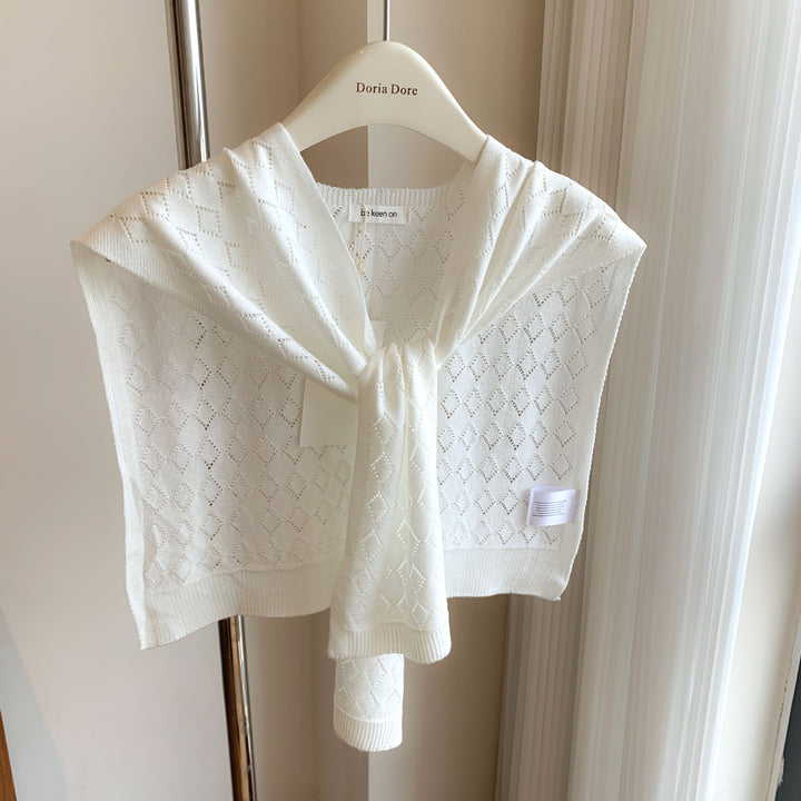 Woman wearing knitted tie front shoulder wrap